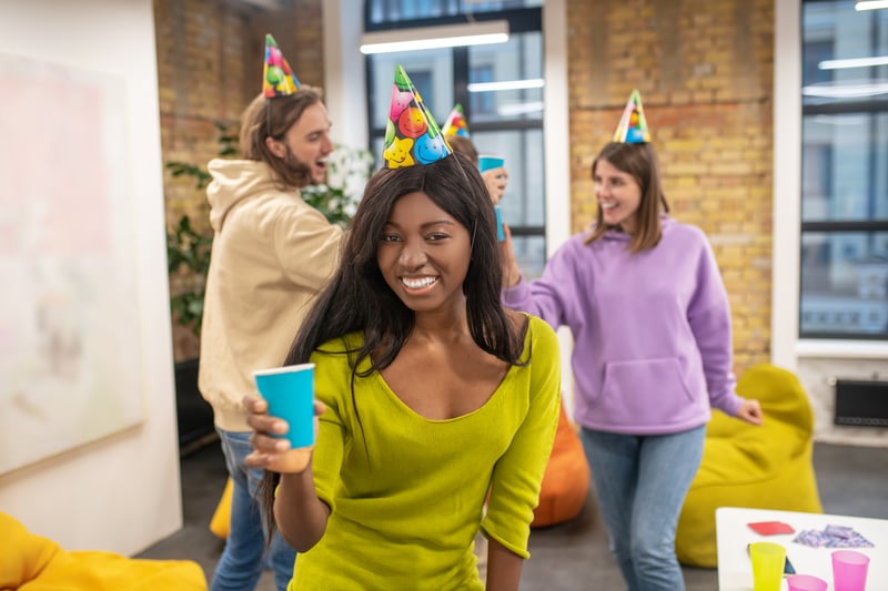 feeling-festive-young-people-celebrating-office-looking-happy-enjoyed